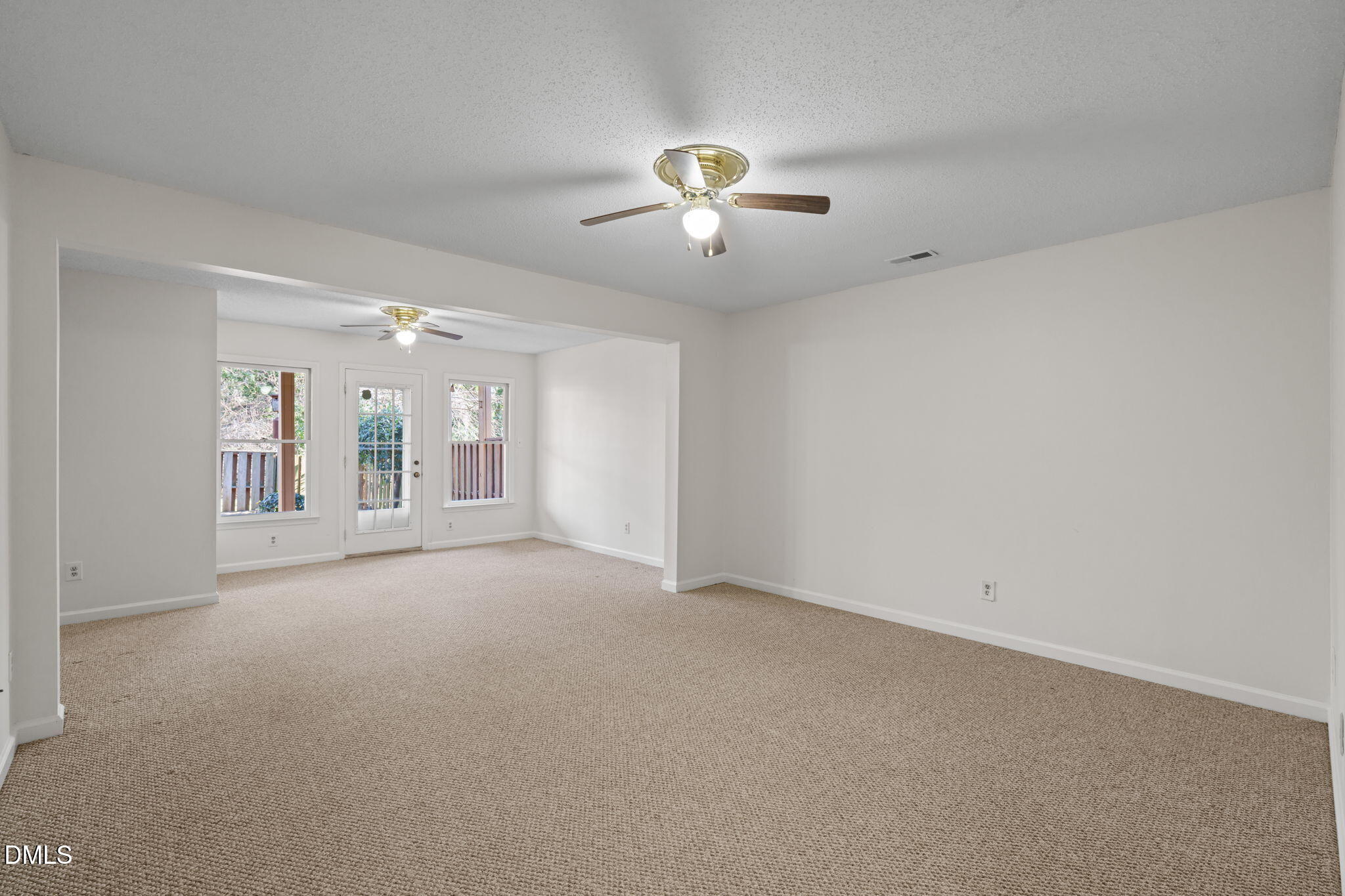 1424 Mapleside Court Raleigh, NC 27609 - Photo 35 of 72 an empty room with chandelier fan and windows
