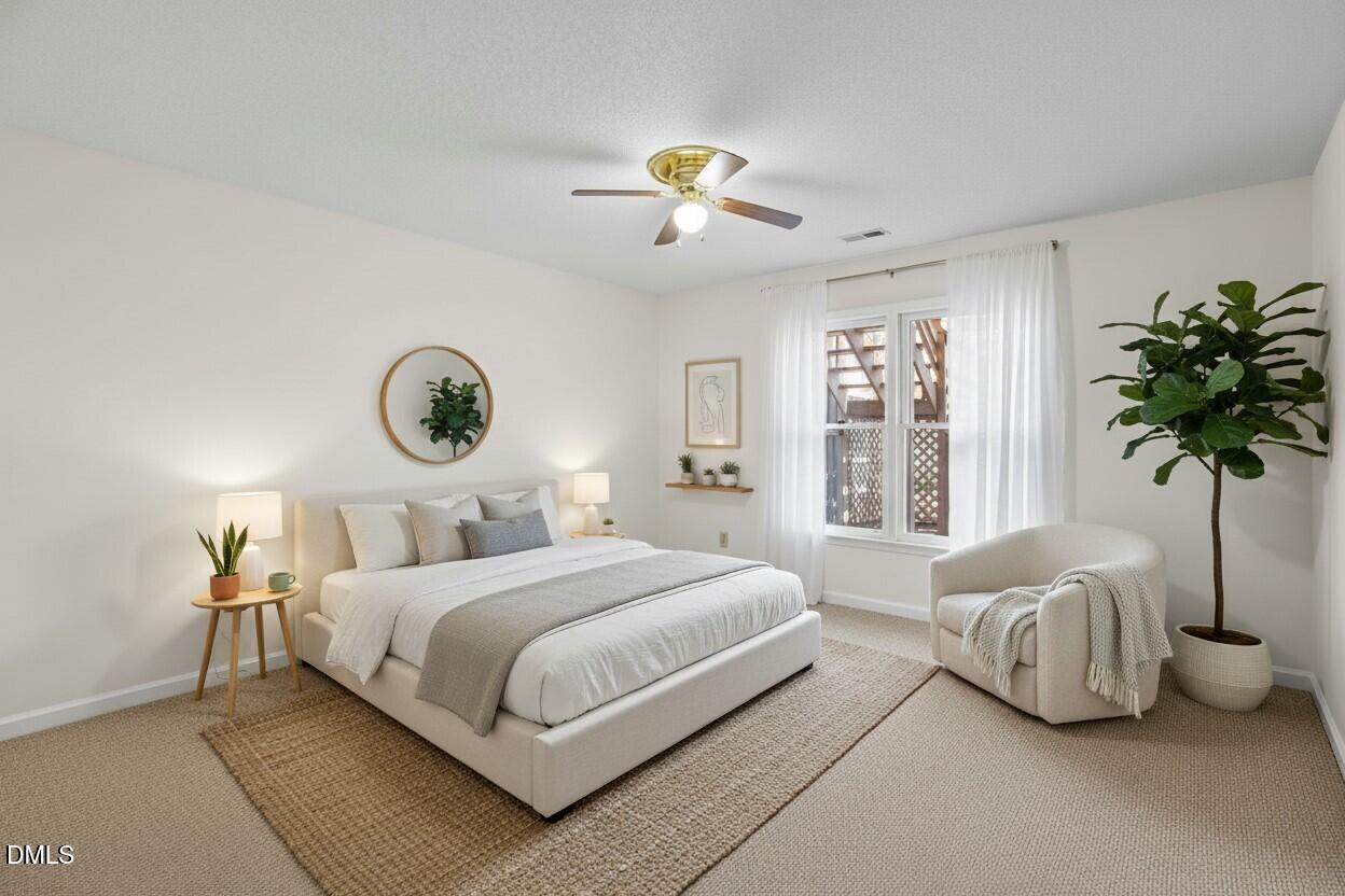 1424 Mapleside Court Raleigh, NC 27609 - Photo 7 of 72 a bedroom with a bed and a chandelier