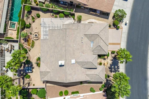an aerial view of a house with a yard and potted plants