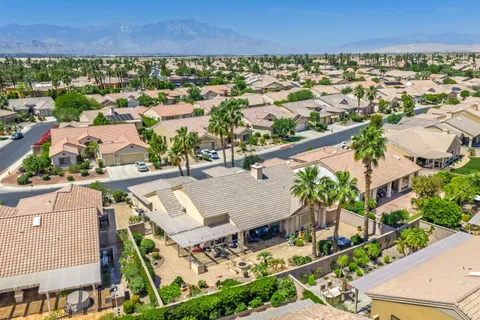 an aerial view of residential houses with outdoor space and parking