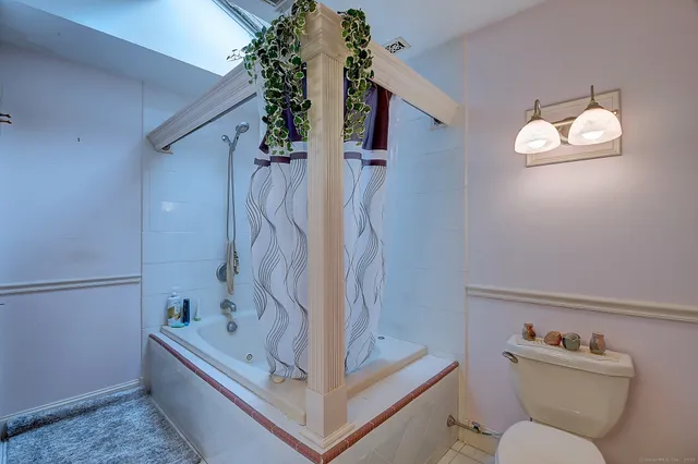a bathroom with a toilet sink and tub