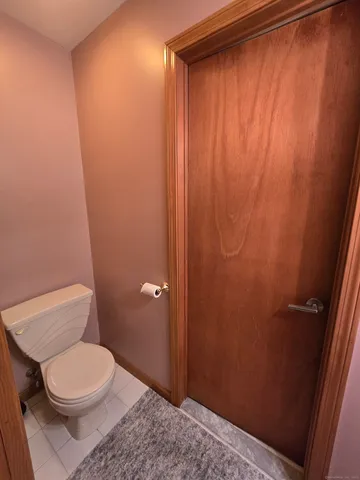 a white toilet sitting next to a shower