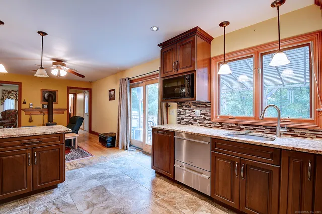 a kitchen with stainless steel appliances granite countertop a stove a sink and a refrigerator