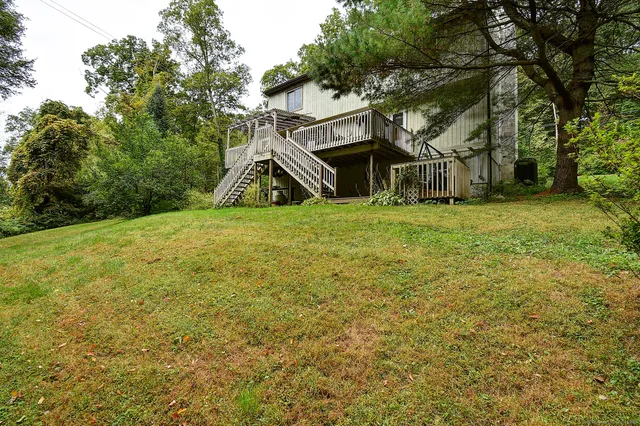 a view of a house with a yard and garage