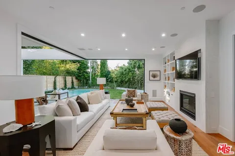 a living room with fireplace furniture and a flat screen tv