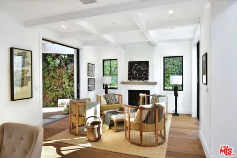 a dining room with furniture window and wooden floor
