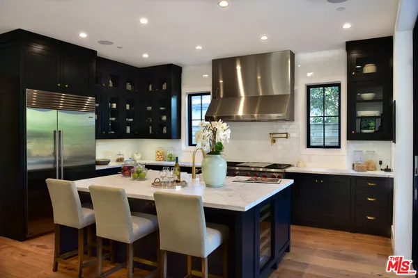 a kitchen with a sink cabinets and window