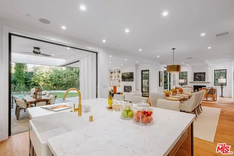 a dining room with furniture a fireplace and a floor to ceiling window