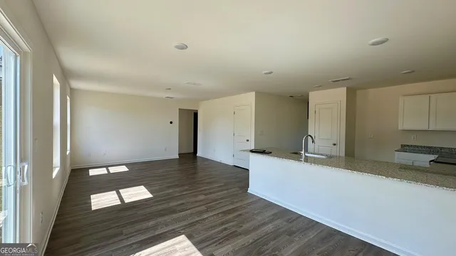 a kitchen with a wooden floor and a sink