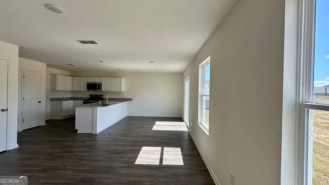 a kitchen with stainless steel appliances kitchen island granite countertop a refrigerator and a stove top oven