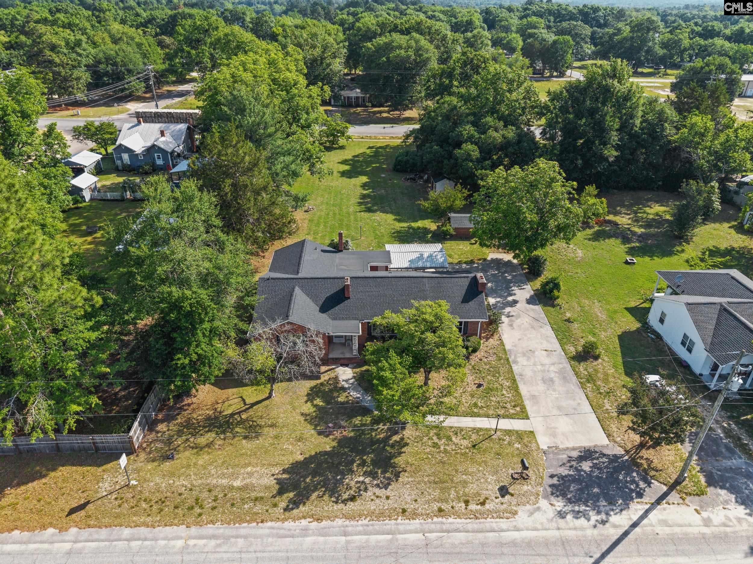 729 Magnolia Street Pelion, SC 29123 - Photo 32 of 32 an aerial view of a house with a yard basket ball court and outdoor seating