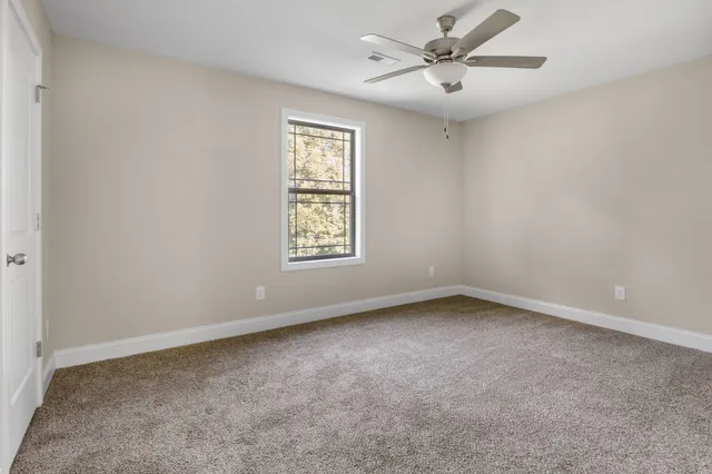 a view of an empty room and closet area