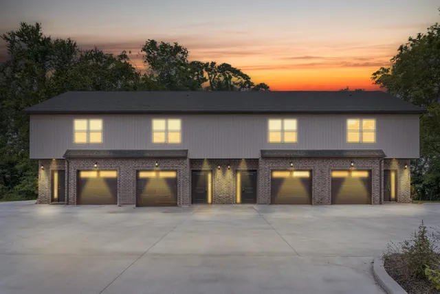 a front view of a building with parking