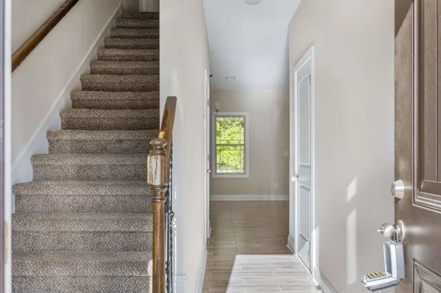 a view of entryway and hall with wooden floor