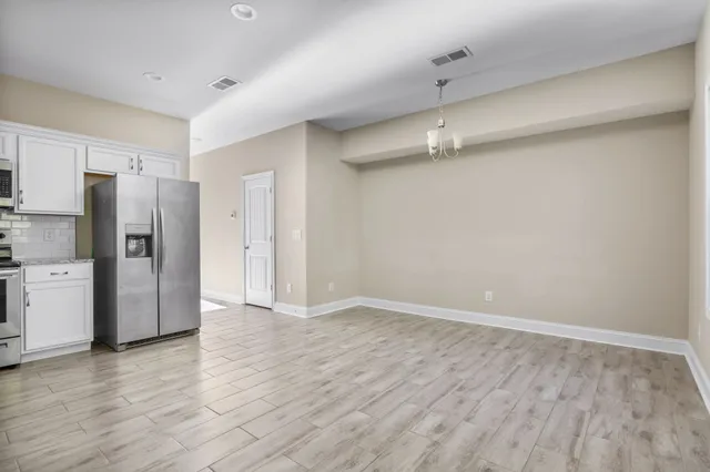a view of a kitchen with a refrigerator and a sink