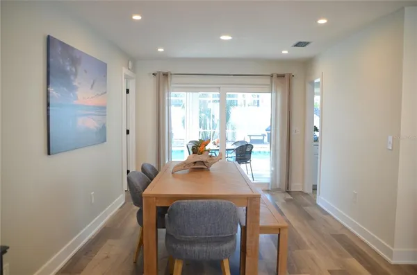 a view of a dining room with furniture and wooden floor
