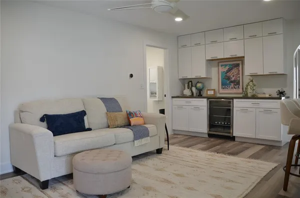 a living room with furniture and a kitchen view