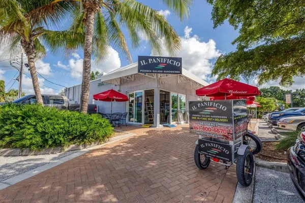 a group of people sitting in front of retail shop