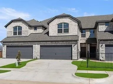 a front view of a house with a garden and plants