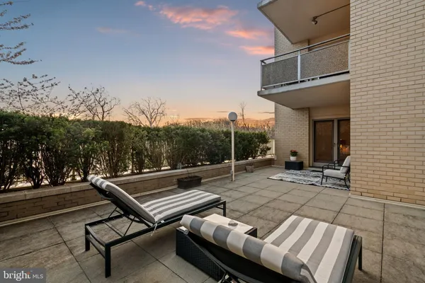 a backyard of a house with table and chairs