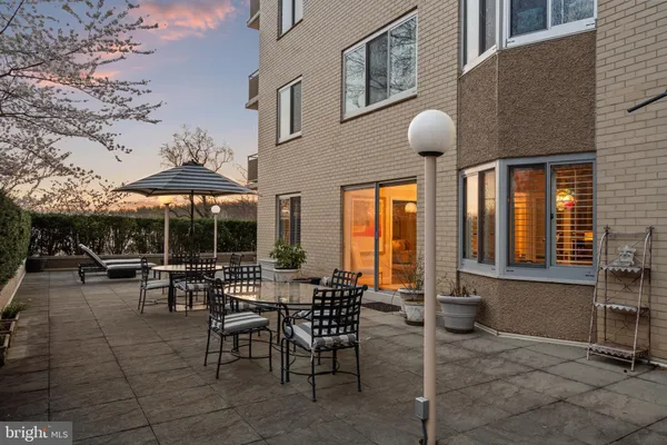 a view of a patio with a table and chairs under an umbrella