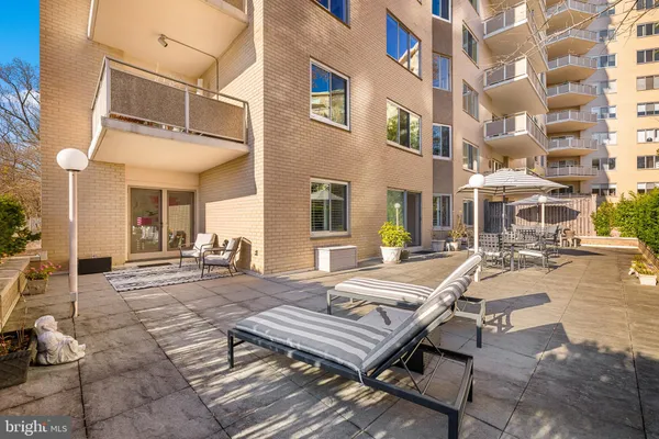 a view of a patio with a dining table and chairs with wooden floor