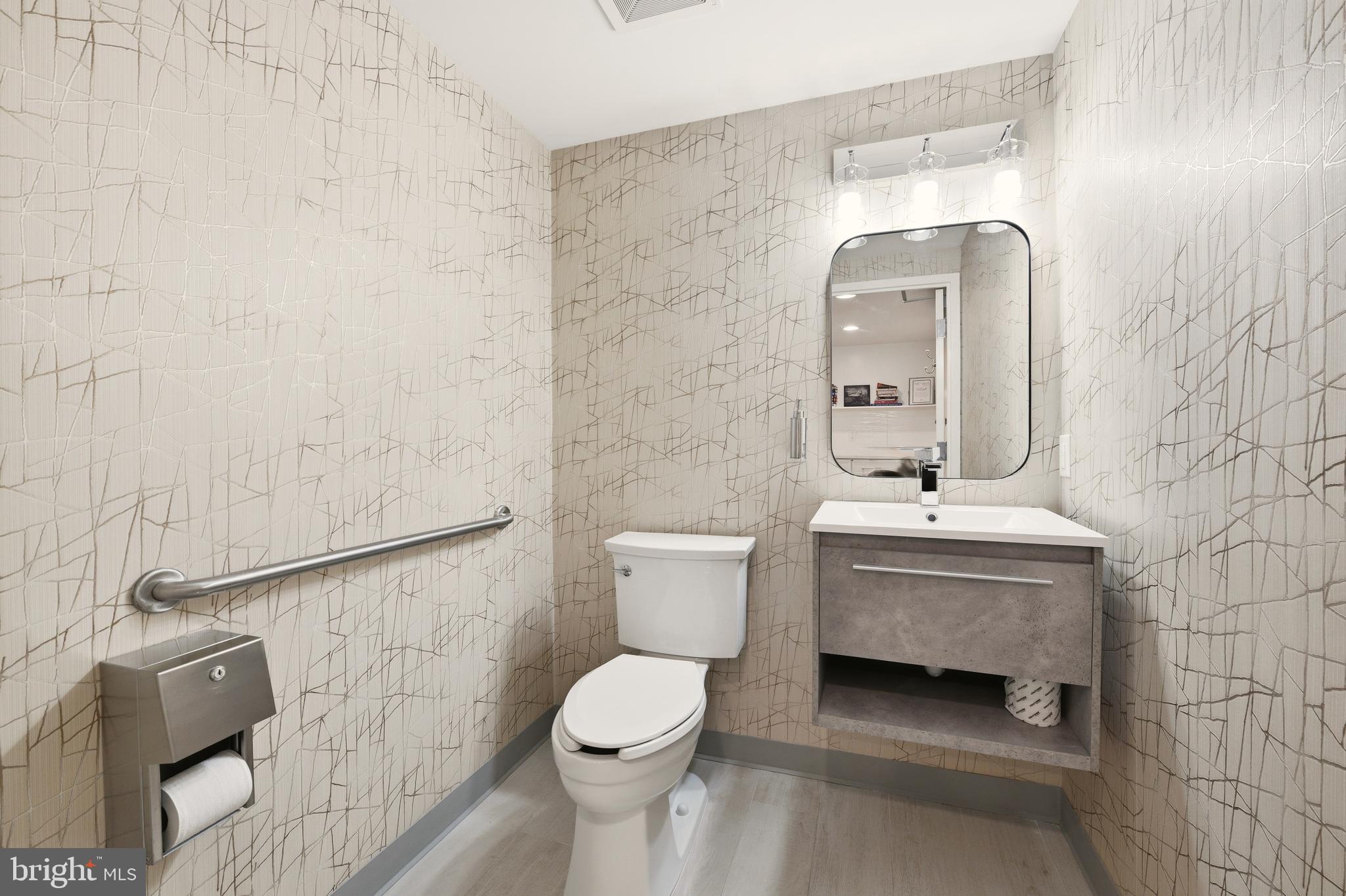 1150 K Street Northwest, Unit 1109 Washington, DC 20005 - Photo 28 of 33 a bathroom with a toilet sink and mirror