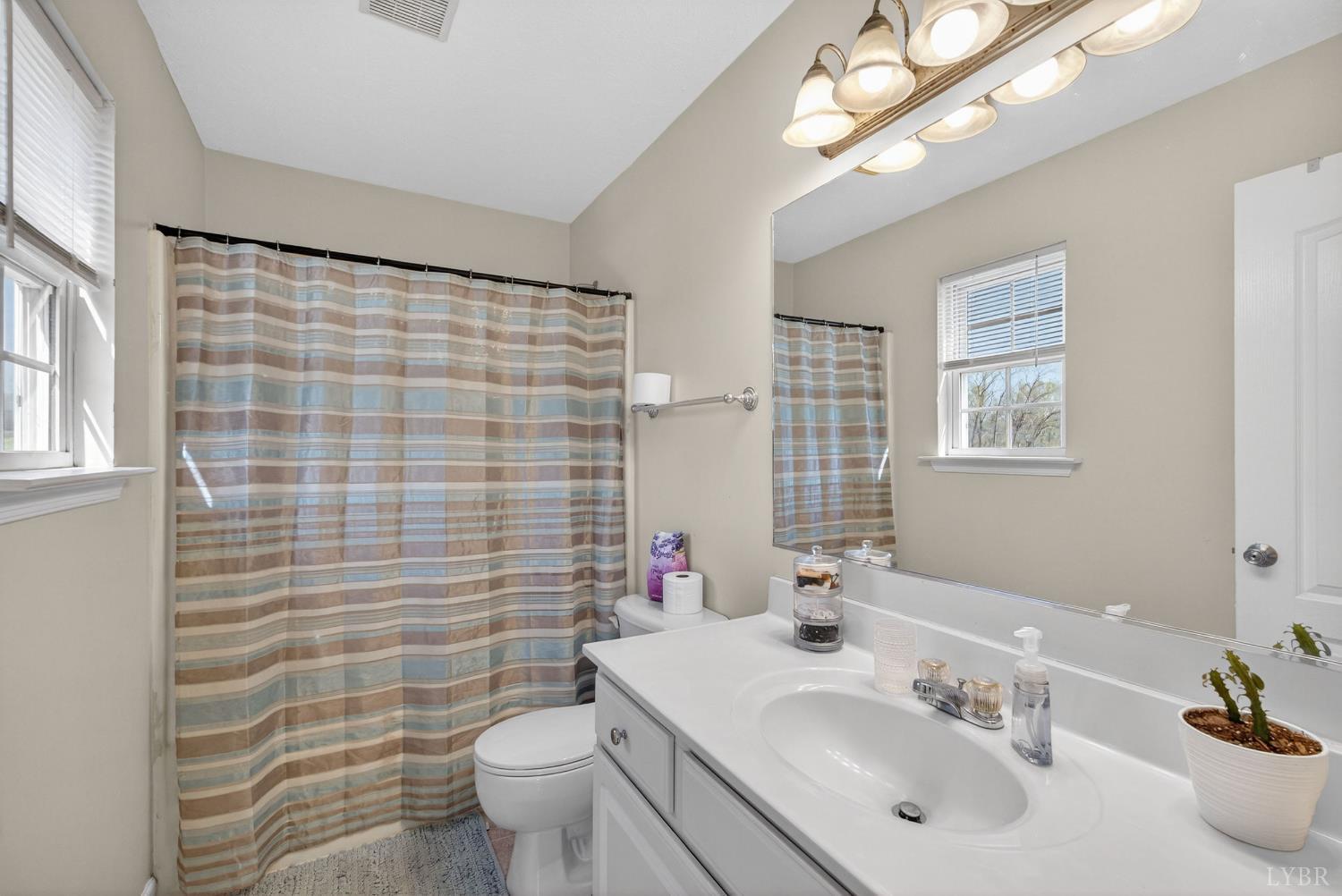 211 Wessex Road Lynchburg, VA 24501 - Photo 32 of 56 a bathroom with a sink a toilet and shower curtain
