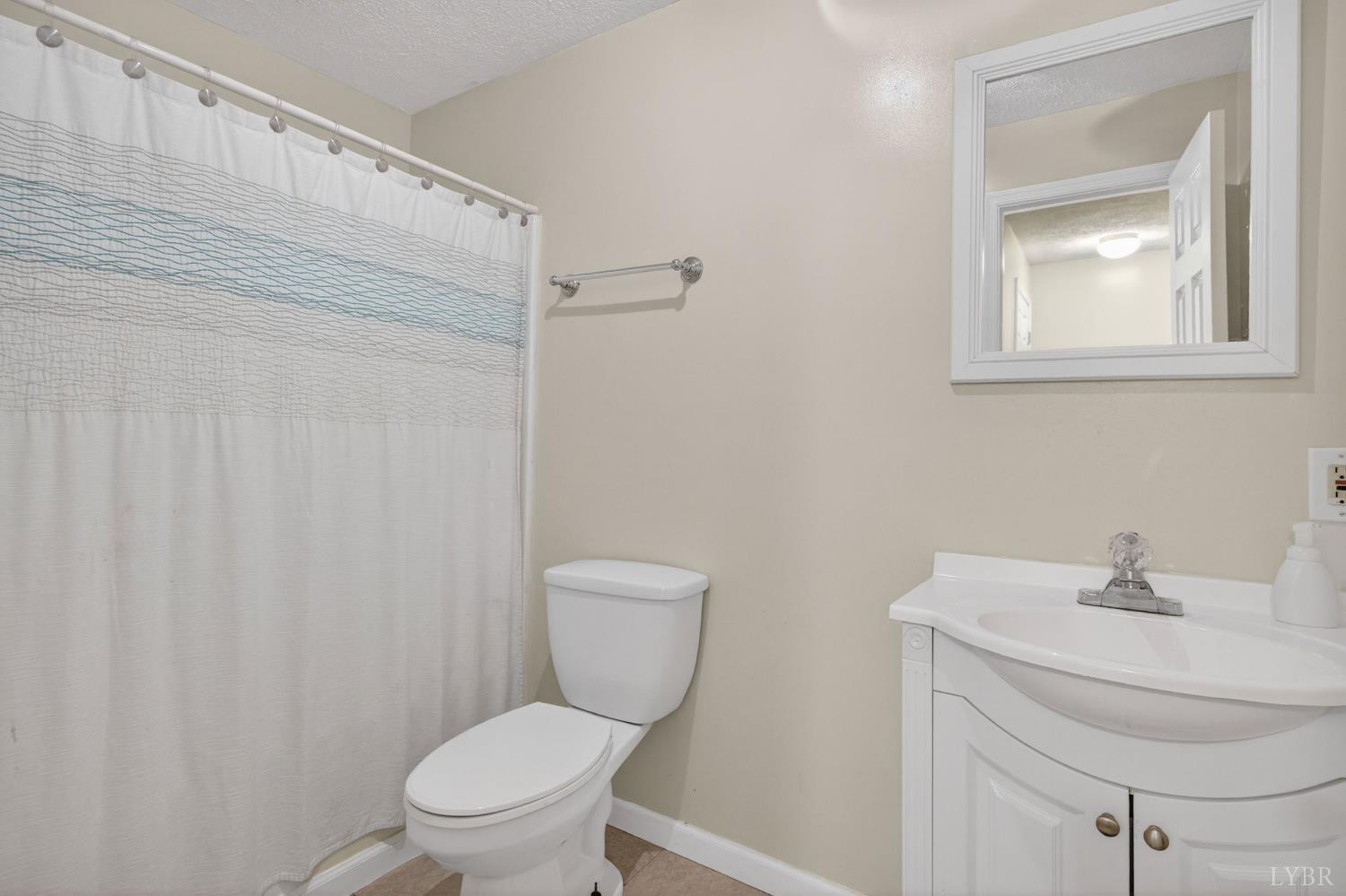 211 Wessex Road Lynchburg, VA 24501 - Photo 36 of 56 a bathroom with a toilet a sink and mirror