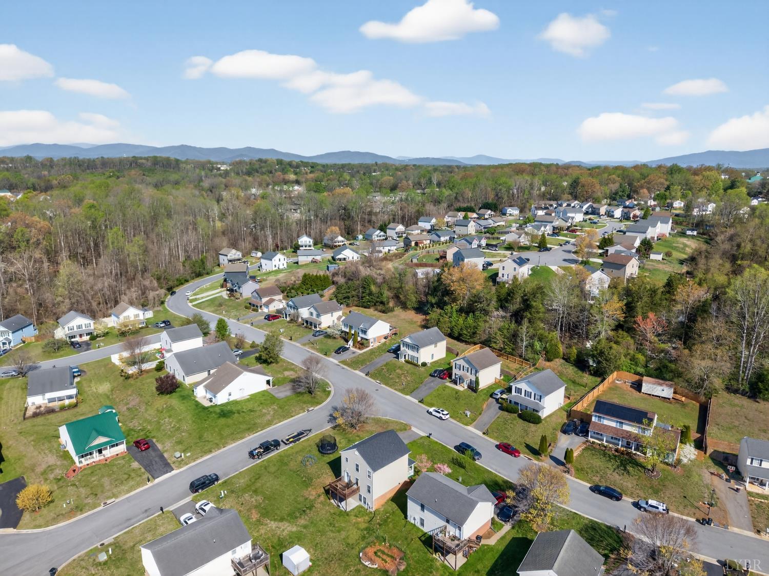 211 Wessex Road Lynchburg, VA 24501 - Photo 56 of 56 an aerial view of a city with lots of residential buildings and mountain view in back