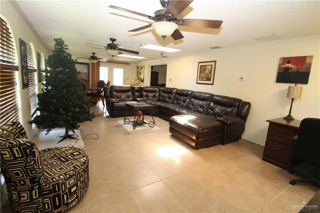 110 Avenida Morelos Rancho Viejo, TX 78575 - Photo 12 of 19 a living room with furniture ceiling fan and a rug