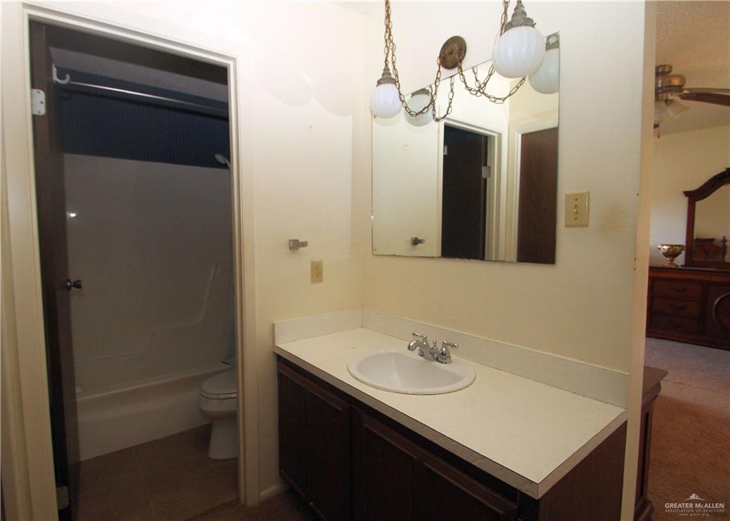 110 Avenida Morelos Rancho Viejo, TX 78575 - Photo 16 of 19 a bathroom with a sink and a mirror