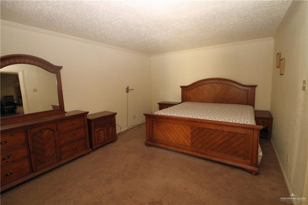 110 Avenida Morelos Rancho Viejo, TX 78575 - Photo 4 of 19 a bedroom with a bed and cabinet