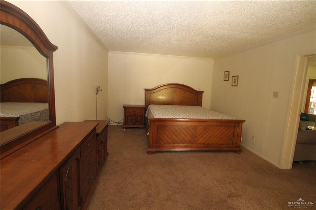 110 Avenida Morelos Rancho Viejo, TX 78575 - Photo 5 of 19 a living room with a couch and a flat screen tv