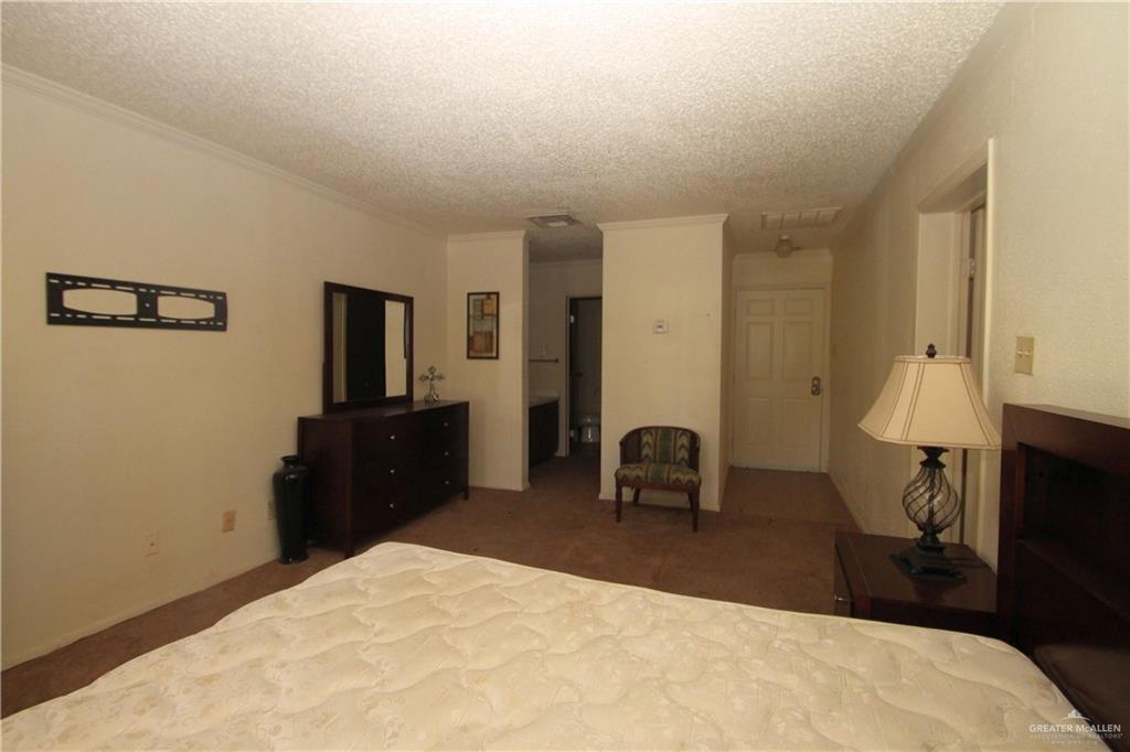 110 Avenida Morelos Rancho Viejo, TX 78575 - Photo 10 of 19 a bedroom with a bed and a flat screen tv