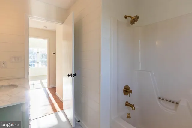 a bathroom with a bathtub and shower