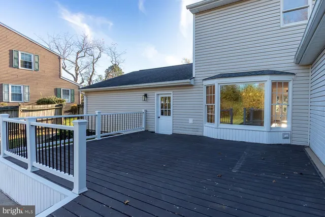 a view of backyard with deck and wooden floor