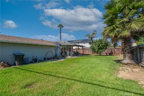 a view of a backyard with sitting area furniture and garden