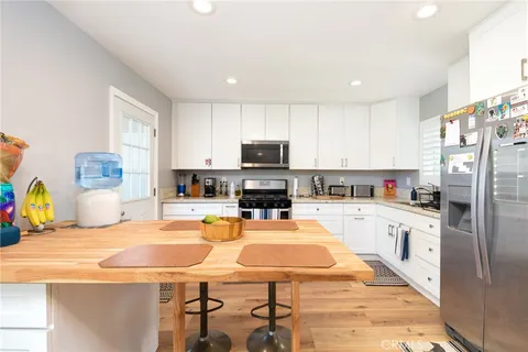 a kitchen with a stove a sink and a refrigerator