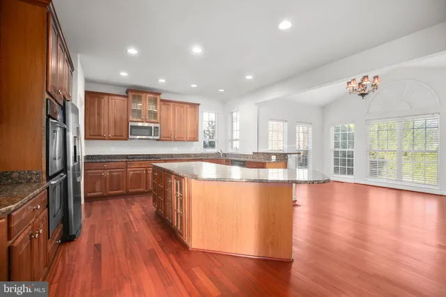 a kitchen with stainless steel appliances granite countertop a refrigerator and a sink