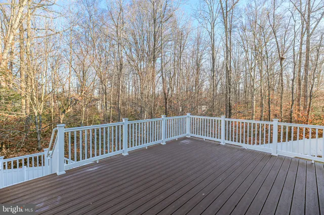 a view of backyard with deck and wooden floor
