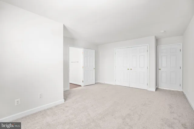 an empty room with a empty space and windows