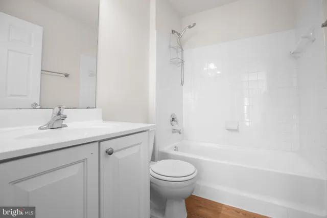 a living room with granite countertop white cabinets and window