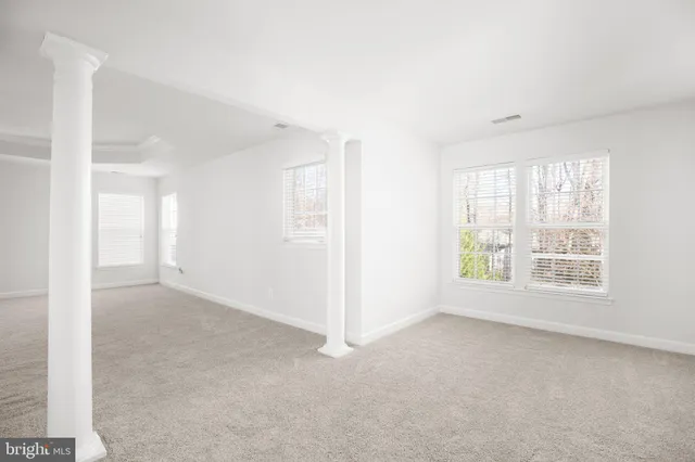 a spacious bathroom with a granite countertop sink a mirror and a bathtub