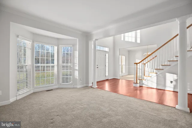 a view of an empty room with large windows