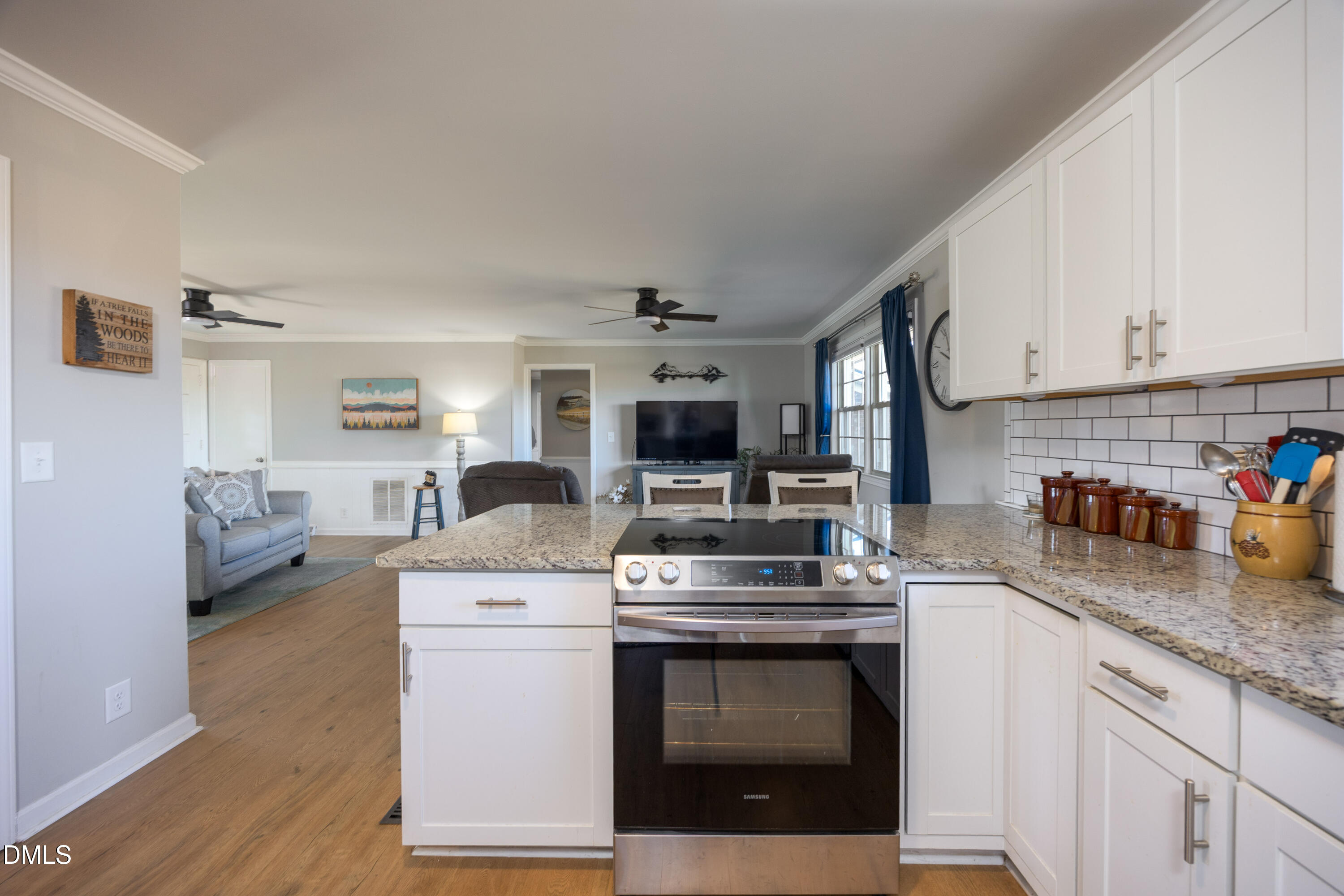 760 Eugene Jernigan Road Dunn, NC 28334 - Photo 13 of 30 a kitchen with stainless steel appliances granite countertop a stove a sink dishwasher and a microwave oven with white cabinets