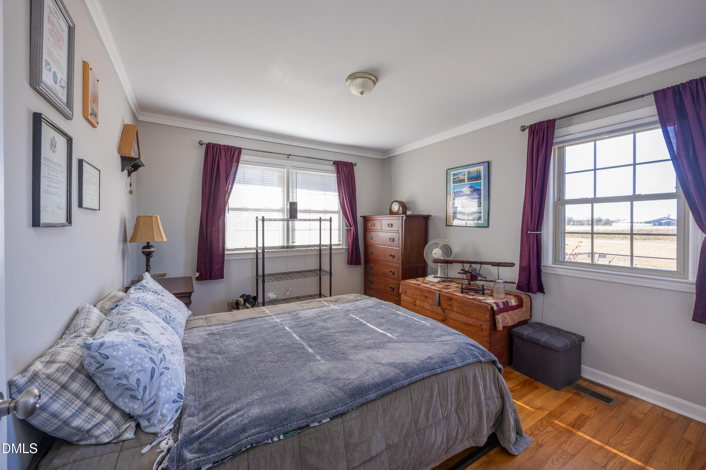 760 Eugene Jernigan Road Dunn, NC 28334 - Photo 20 of 30 a bedroom with a bed and wooden floor