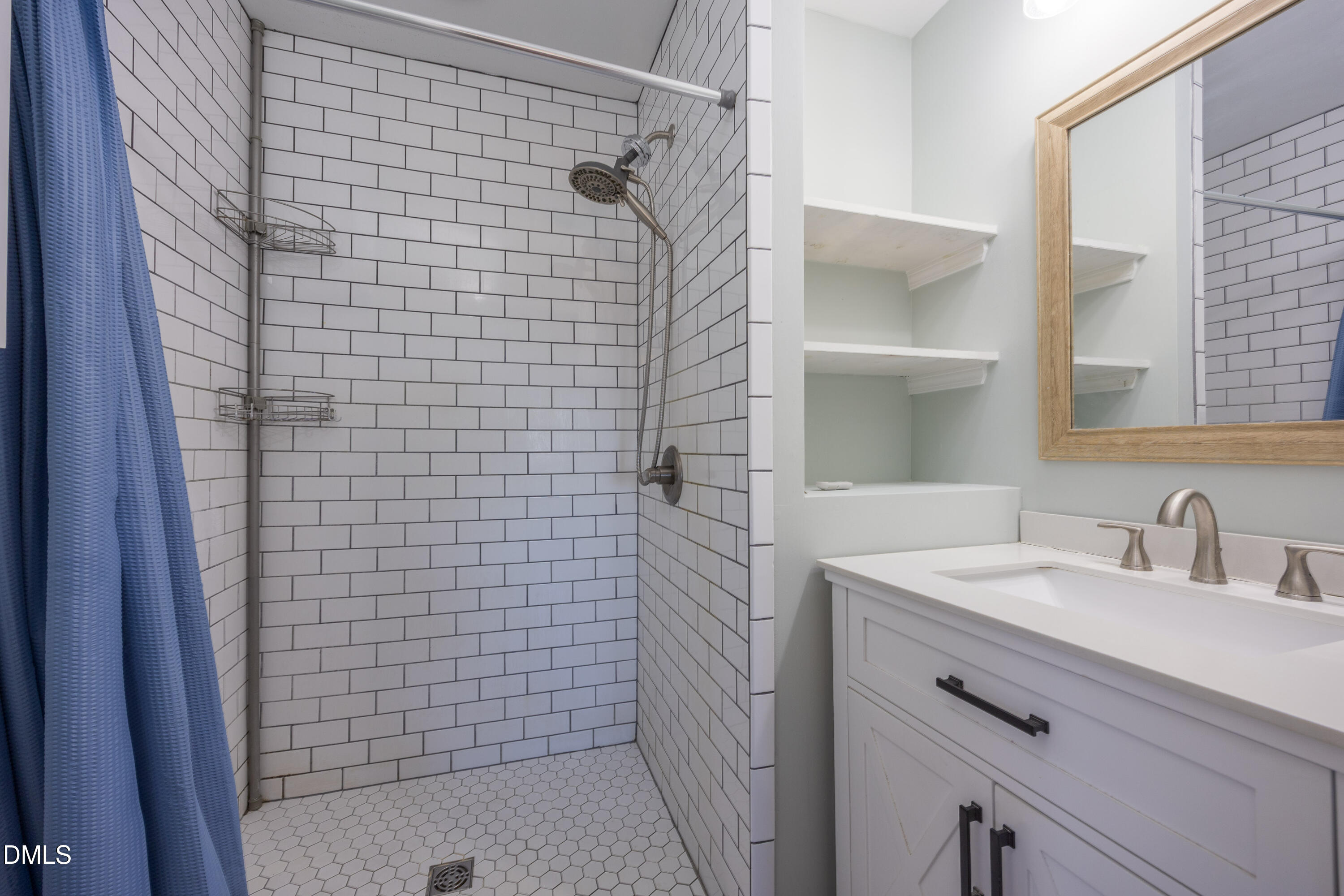 760 Eugene Jernigan Road Dunn, NC 28334 - Photo 24 of 30 a bathroom with a sink a shower and a mirror