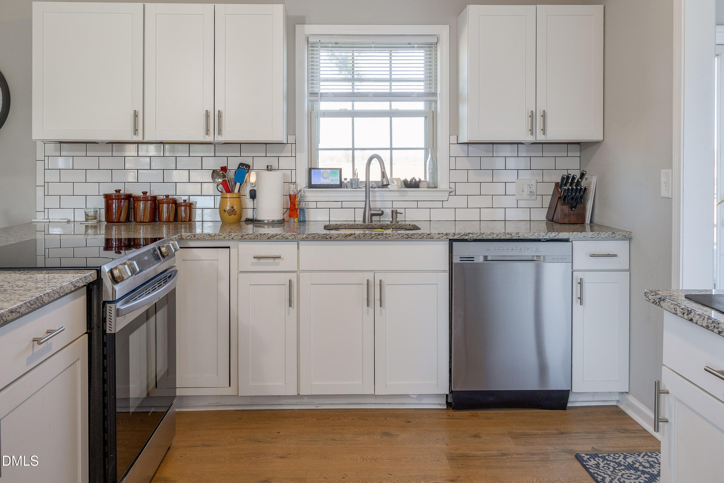 760 Eugene Jernigan Road Dunn, NC 28334 - Photo 9 of 30 a kitchen with granite countertop a sink window and cabinets