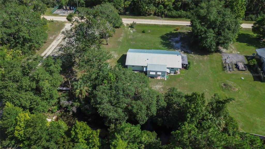 22040 Blue Creek Lodge Road Astor, FL 32102 - Photo 1 of 42 an aerial view of a house with a yard